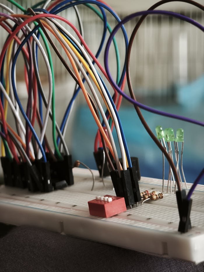 A detailed view of a breadboard setup with multicolored wires and components.
